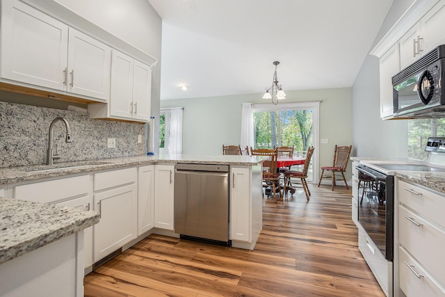 1407 S Dibble St, Hastings, MI 49058 - kitchen featuring electric range, black microwave, stainless steel dishwasher, a sink, and white cabinets