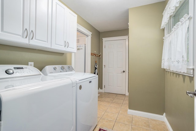 1407 S Dibble St, Hastings, MI 49058 - laundry area with cabinet space, washer and clothes dryer, light tile patterned floors, and baseboards