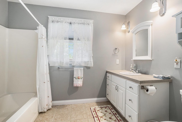 1407 S Dibble St, Hastings, MI 49058 - full bath with vanity, shower / bath combo with shower curtain, baseboards, toilet, and tile patterned flooring