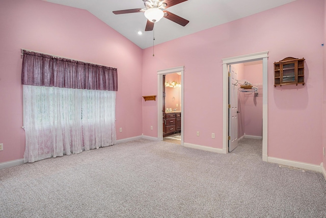 1407 S Dibble St, Hastings, MI 49058 - unfurnished bedroom with baseboards, carpet floors, high vaulted ceiling, a spacious closet, and connected bathroom