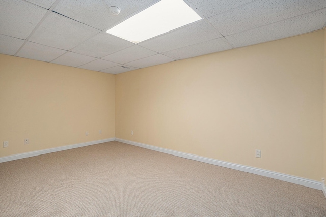 1407 S Dibble St, Hastings, MI 49058 - empty room featuring a drop ceiling, carpet, and baseboards