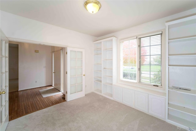 6169 Valley View Dr, Canton, MI 48187 - unfurnished room featuring french doors, carpet flooring, baseboards, and wood finished floors