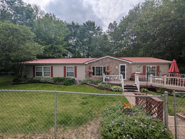 12368 S M 37 Hwy, Delton, MI 49046 - ranch-style home with a wooden deck, metal roof, and stone siding