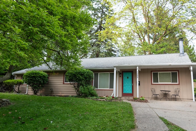 1204 Bydding Rd, Ann Arbor, MI 48103 - single story home with a front lawn, a shingled roof, and board and batten siding
