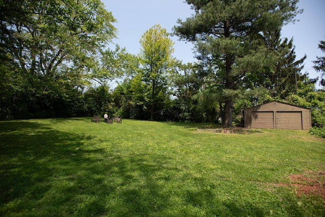 1204 Bydding Rd, Ann Arbor, MI 48103 - view of grassy yard with an outbuilding and a garage