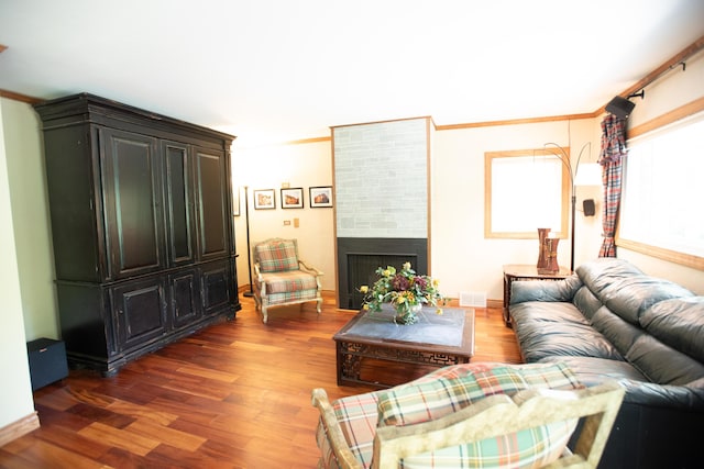 1204 Bydding Rd, Ann Arbor, MI 48103 - living room featuring wood finished floors, a fireplace, and ornamental molding
