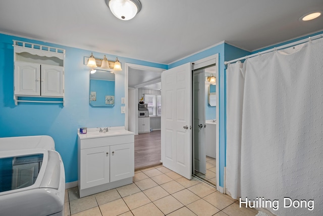 45 S Park St, Muskegon, MI 49442 - bathroom with vanity, tile patterned flooring, a shower with shower curtain, and washer / clothes dryer