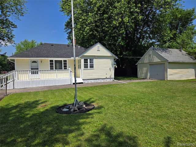 3263 Beechwood St, Monroe, MI 48162 - back of property with an outbuilding, a yard, a detached garage, and a shingled roof