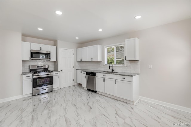 17877 Rowe St, Detroit, MI 48205 - kitchen featuring appliances with stainless steel finishes, a sink, light marble finish floors, light stone countertops, and white cabinetry