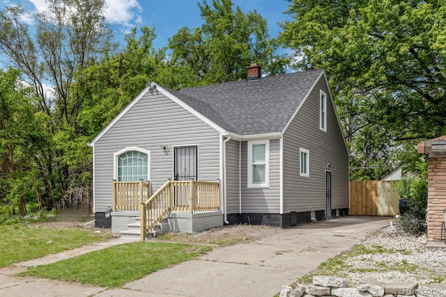 17877 Rowe St, Detroit, MI 48205 - view of front of house with a shingled roof and a chimney