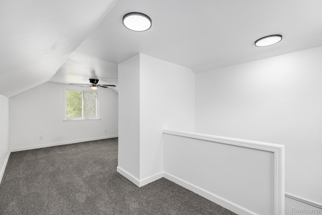 17877 Rowe St, Detroit, MI 48205 - additional living space with dark colored carpet, vaulted ceiling, baseboards, and a ceiling fan
