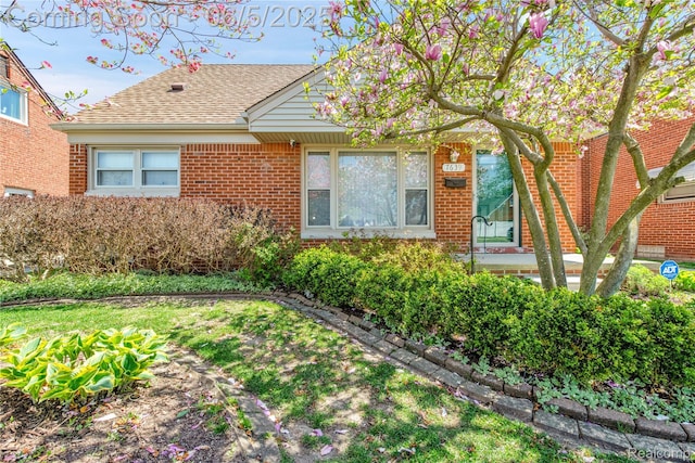 7639 Polk St, Taylor, MI 48180 - view of front of house featuring brick siding and roof with shingles