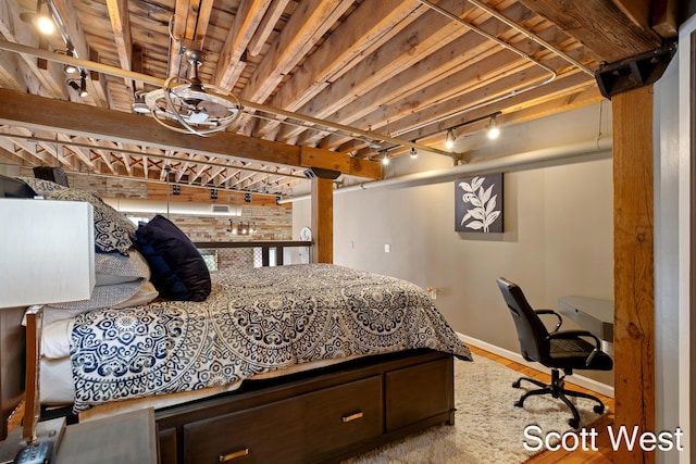 801 Monroe Ave NW Unit 402, Grand Rapids, MI 49503 - bedroom featuring baseboards, wood finished floors, and track lighting