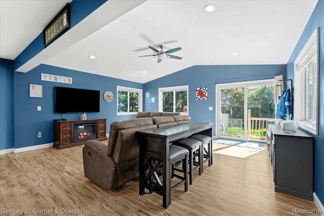 2566 Marchar Dr, Wolverine Lake, MI 48390 - living area featuring light wood-style flooring, vaulted ceiling, a ceiling fan, healthy amount of natural light, and baseboards