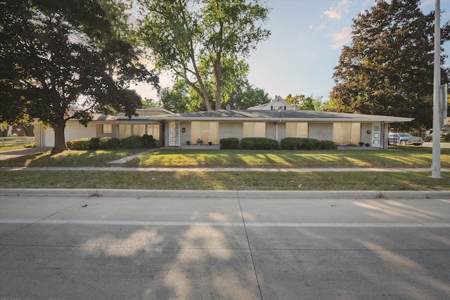 2910 Elizabeth St, Wayne, MI 48184 - view of front of house featuring a front yard, a garage, and concrete driveway