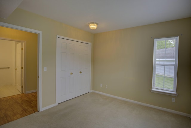 920 Oakbrook Dr, Jackson, MI 49203 - unfurnished bedroom with carpet flooring, baseboards, and a closet