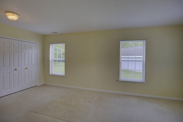 920 Oakbrook Dr, Jackson, MI 49203 - unfurnished bedroom with carpet flooring, baseboards, and a closet
