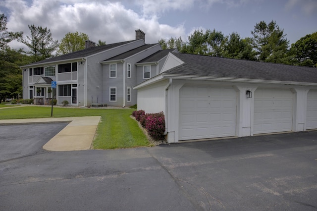 920 Oakbrook Dr, Jackson, MI 49203 - view of front of property with a chimney and a front yard