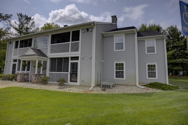 920 Oakbrook Dr, Jackson, MI 49203 - back of property featuring a chimney, a balcony, and a yard