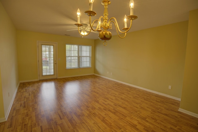920 Oakbrook Dr, Jackson, MI 49203 - spare room with a chandelier, wood finished floors, baseboards, and ceiling fan