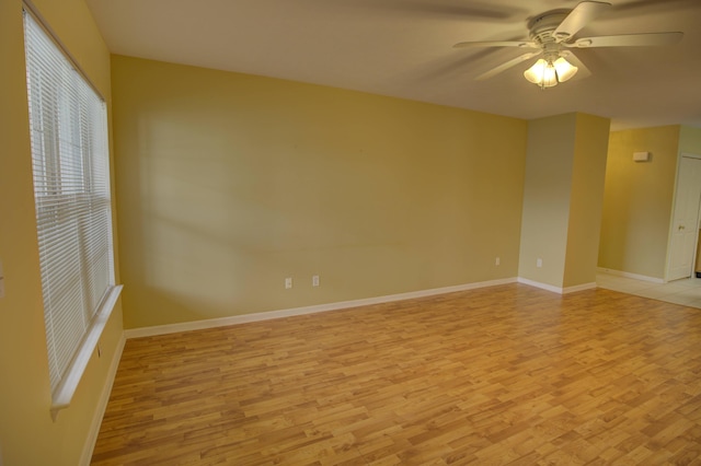 920 Oakbrook Dr, Jackson, MI 49203 - spare room featuring light wood finished floors, a ceiling fan, and baseboards