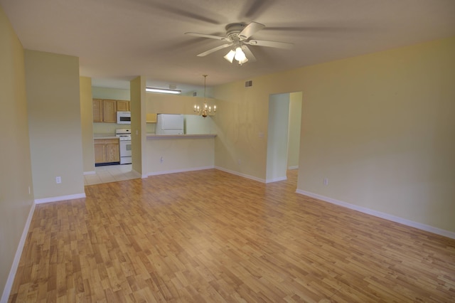 920 Oakbrook Dr, Jackson, MI 49203 - unfurnished living room with light wood-style flooring, a chandelier, ceiling fan, and baseboards