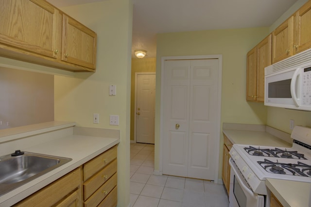 920 Oakbrook Dr, Jackson, MI 49203 - kitchen featuring white appliances, light tile patterned flooring, a sink, and light countertops