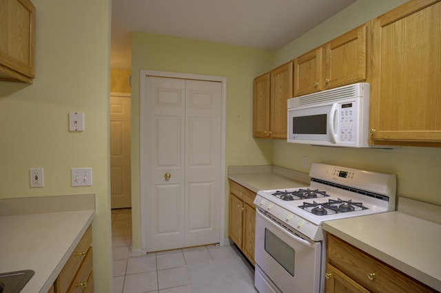 920 Oakbrook Dr, Jackson, MI 49203 - kitchen with white appliances, light tile patterned flooring, and light countertops