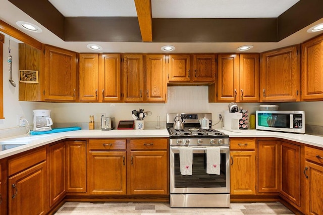 917 Kensington Dr, Niles, MI 49120 - kitchen with appliances with stainless steel finishes, brown cabinets, light countertops, and recessed lighting