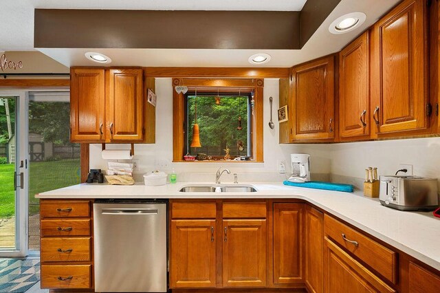917 Kensington Dr, Niles, MI 49120 - kitchen with stainless steel dishwasher, a sink, light countertops, brown cabinetry, and recessed lighting