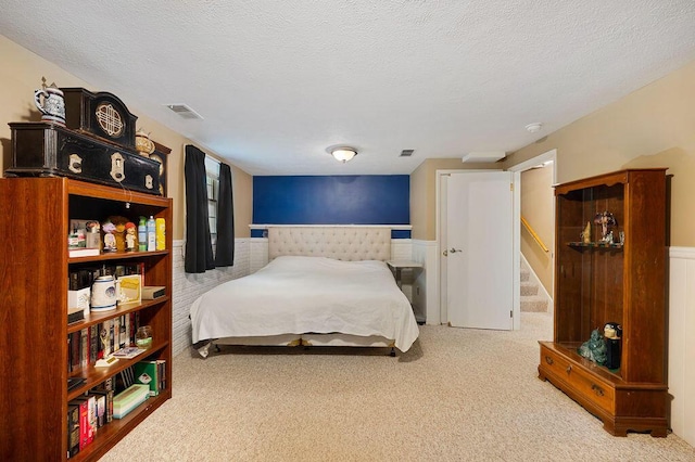 917 Kensington Dr, Niles, MI 49120 - bedroom with a wainscoted wall, carpet floors, and a textured ceiling