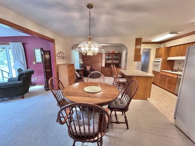 818 W Chestnut St, Morenci, MI 49256 - dining space featuring arched walkways, a chandelier, and light carpet