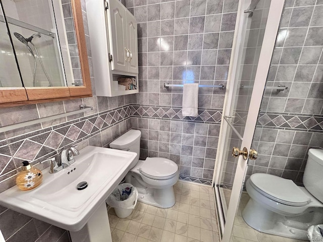 818 W Chestnut St, Morenci, MI 49256 - full bathroom featuring tile walls, toilet, a stall shower, and a sink