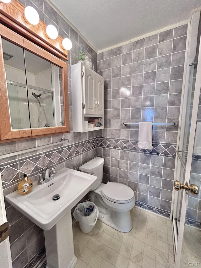 818 W Chestnut St, Morenci, MI 49256 - full bath featuring tile walls, a shower stall, toilet, and a sink