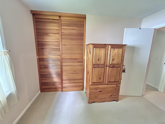 818 W Chestnut St, Morenci, MI 49256 - unfurnished bedroom with a closet, baseboards, and light carpet