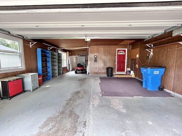 818 W Chestnut St, Morenci, MI 49256 - garage featuring wooden walls, a garage door opener, and electric panel