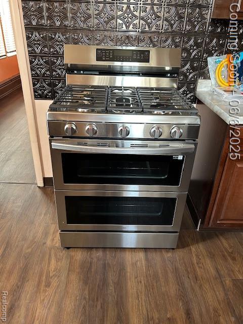 23001 Norfolk St, Detroit, MI 48219 - kitchen view of range with two ovens, dark wood-style flooring, and light countertops