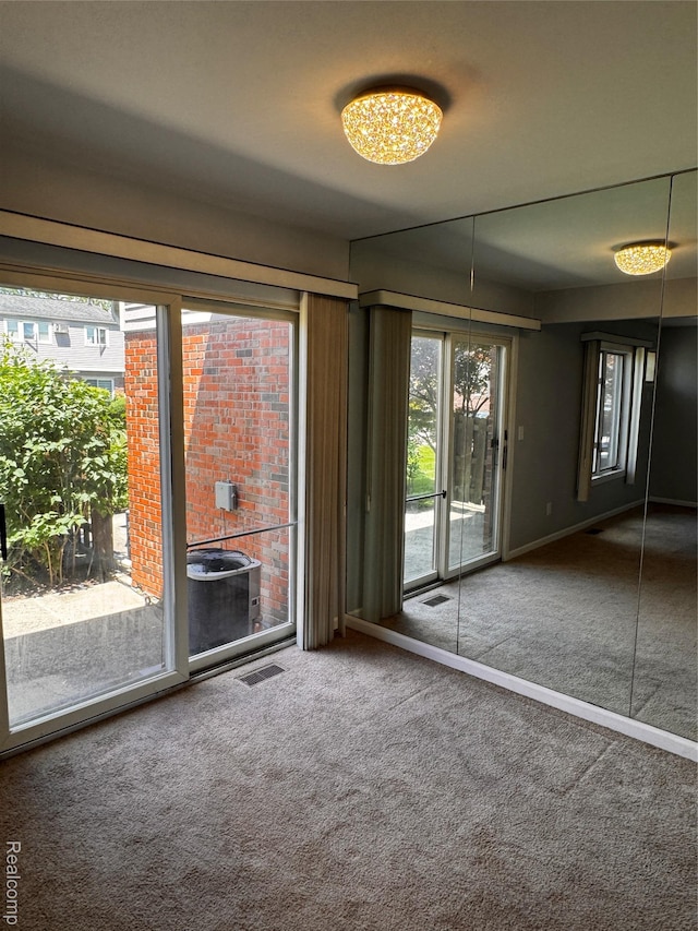 37263 Great Oaks Ct, Clinton Township, MI 48036 - carpeted empty room featuring healthy amount of natural light and a chandelier