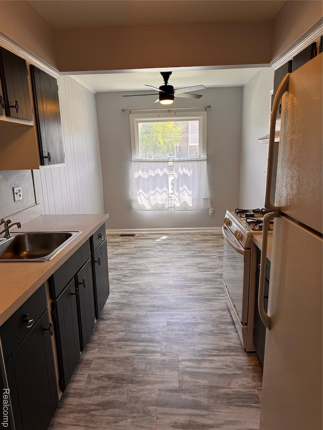 37263 Great Oaks Ct, Clinton Township, MI 48036 - kitchen with white appliances, a sink, a ceiling fan, light countertops, and wood finished floors
