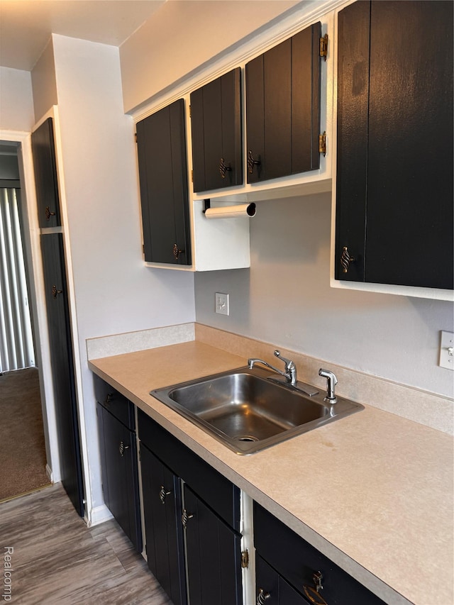 37263 Great Oaks Ct, Clinton Township, MI 48036 - kitchen with light wood-style flooring, light countertops, and dark cabinetry