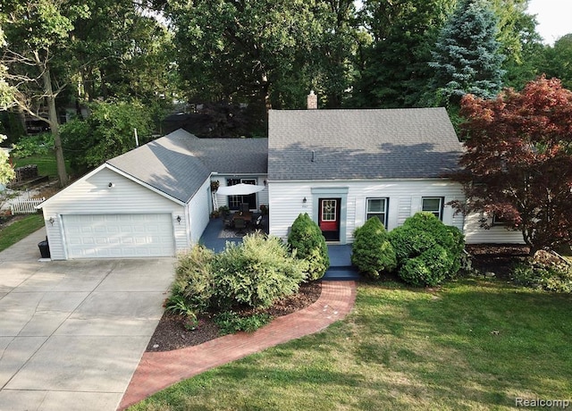 9207 Whitall Ln, Trenton, MI 48138 - new england style home with concrete driveway, a front yard, roof with shingles, a garage, and a chimney