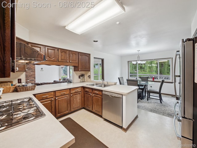 4677 Rolling Ridge Rd, West Bloomfield, MI 48323 - kitchen featuring stainless steel appliances, a sink, light countertops, and a peninsula