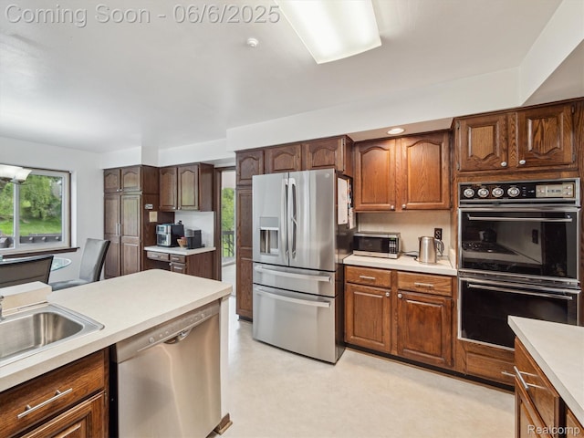 4677 Rolling Ridge Rd, West Bloomfield, MI 48323 - kitchen featuring stainless steel appliances, light countertops, and a sink