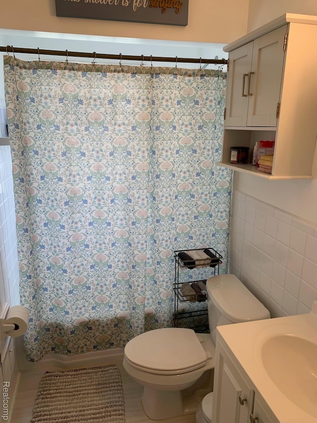 17439 Brody Ave, Allen Park, MI 48101 - bathroom with toilet, vanity, tile walls, and shower / tub combo with curtain