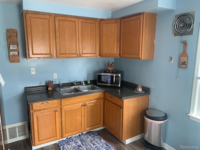 17439 Brody Ave, Allen Park, MI 48101 - kitchen with stainless steel microwave, a sink, dark countertops, and dark wood-type flooring