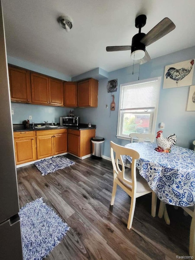 17439 Brody Ave, Allen Park, MI 48101 - kitchen with stainless steel microwave, ceiling fan, dark wood-type flooring, and brown cabinets