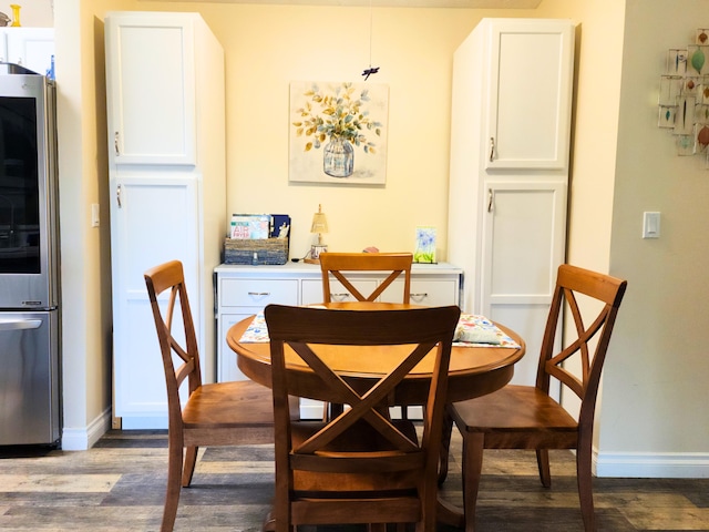 324 Ashley Ct Unit 10, Brooklyn, MI 49230 - dining room featuring dark wood-style flooring and baseboards