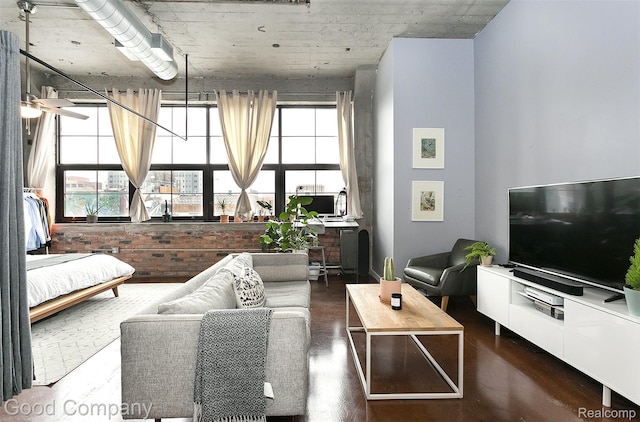 55 W Canfield Unit 210, Detroit, MI 48201 - living area with plenty of natural light, ceiling fan, brick wall, and wood finished floors