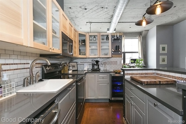 55 W Canfield Unit 210, Detroit, MI 48201 - kitchen with beverage cooler, black appliances, dark countertops, and backsplash