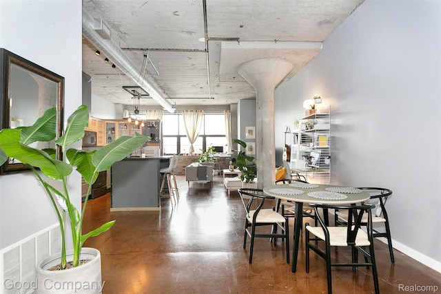 55 W Canfield Unit 210, Detroit, MI 48201 - dining area featuring concrete flooring and baseboards
